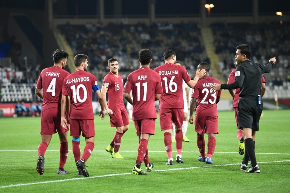 Qatari players celebrate a goal.