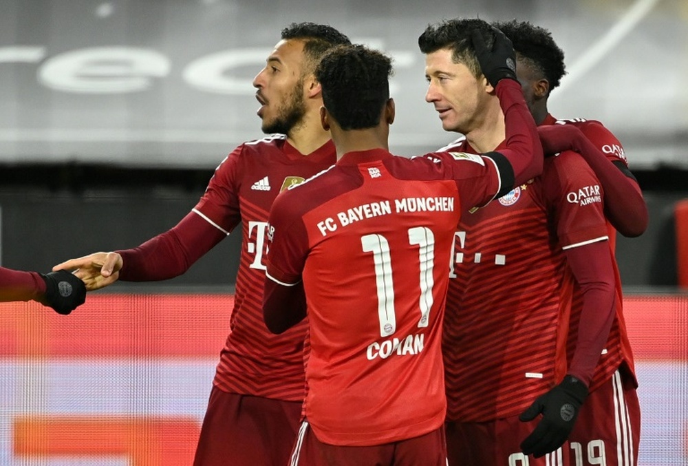 Robert Lewandowski scored twice as Bayern won 2-3 at Dortmund. AFP