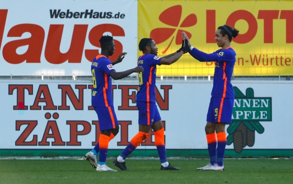 Christopher Nkunku (C) scored in Leipzig's 0-3 win at Freiburg. AFP
