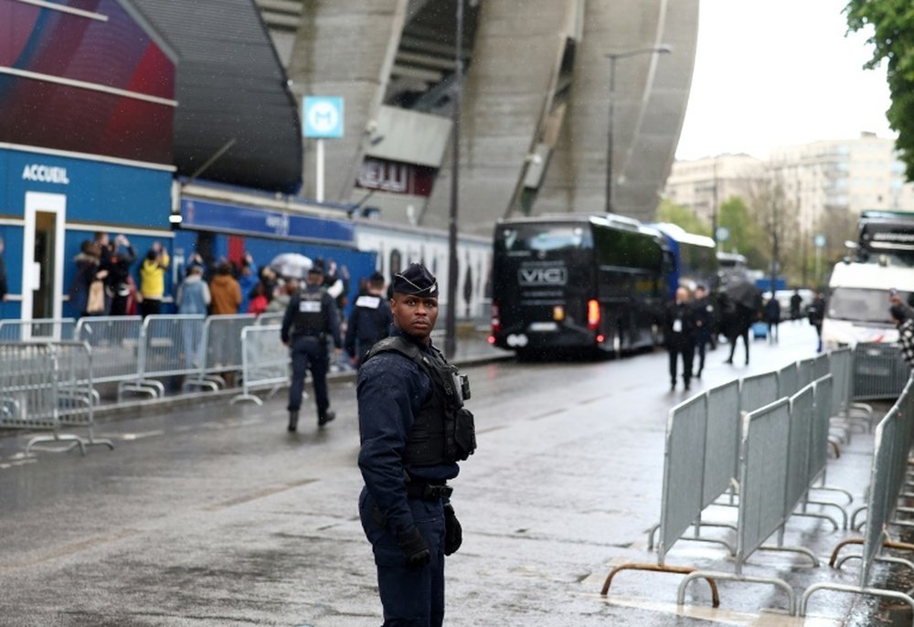 Police stand guard outside the Parc des Princes stadium where PSG will face Barcelona. AFP