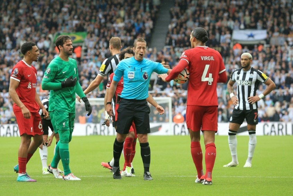 Virgil van Dijk (2R) was sent off at Newcastle. AFP