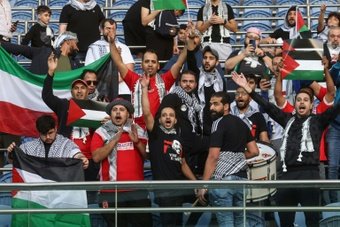 Palestinian flags and the black-and-white keffiyeh scarf flew high in Kuwait's Jaber Al-Ahmad International Stadium as football fans vented their emotions in a World Cup qualifier on Tuesday.