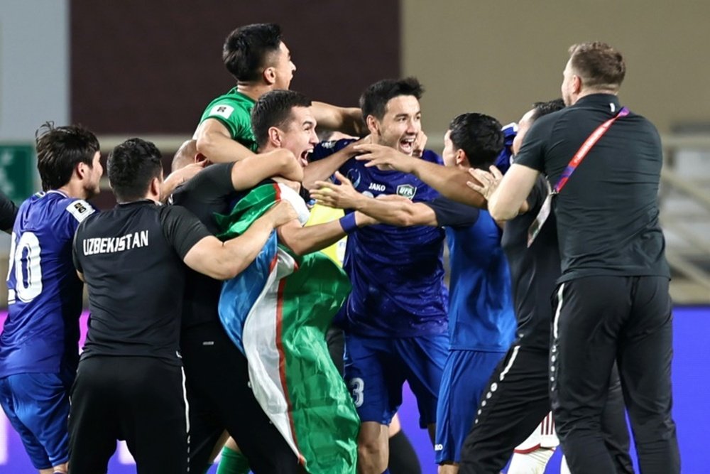 Uzbekistans players celebrate after booking their berth in the FIFA World Cup for the first time.AFP