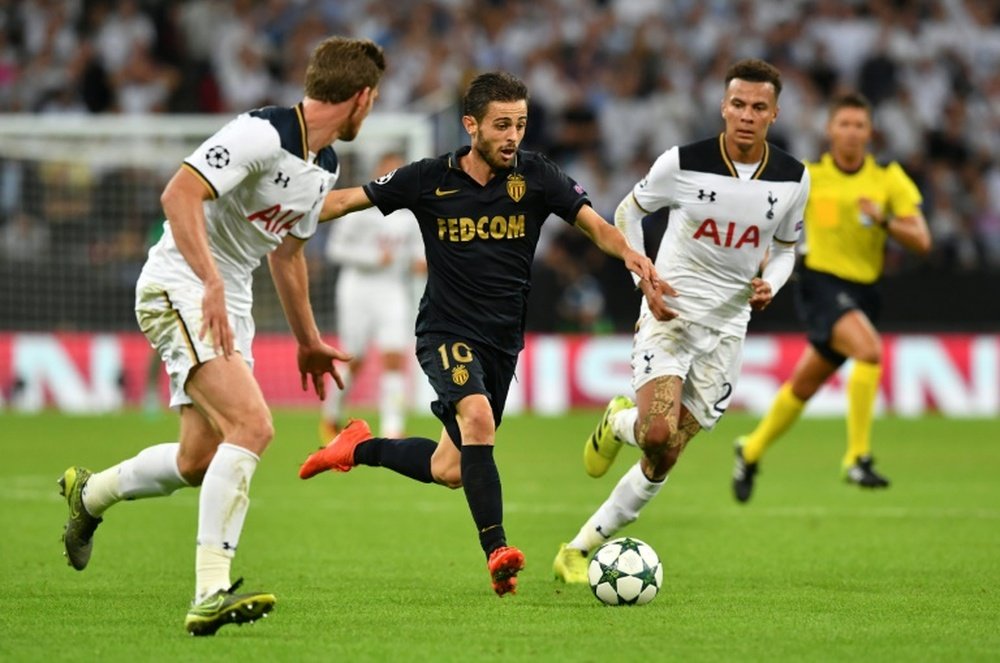 Bernardo Silva runs pastDele Alli during the Champions League group E match at Wembley Stadium. AFP