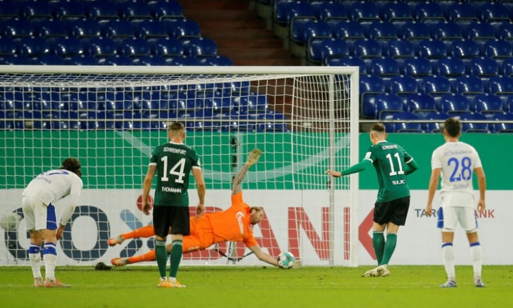 Schalke goalkeeper Ralf Fahrmann (C) saves a penalty from Schweinfurts Amar Suljic. AFP