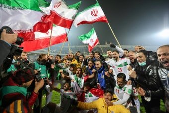 Irans players celebrate with fans after qualifying for the 2022 World Cup finals in Qatar. AFP