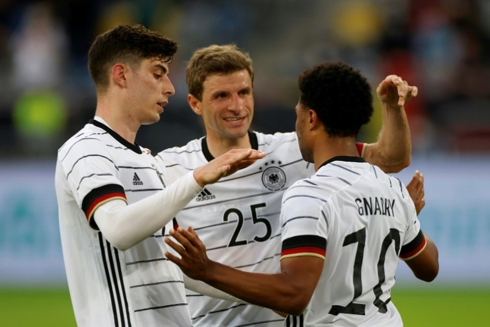 Kai Havertz (L) and Thomas Mueller (C) celebrate with Gnabry. AFP