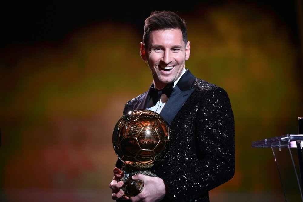 Lionel Messi poses with his seventh Ballon dOr trophy. AFP