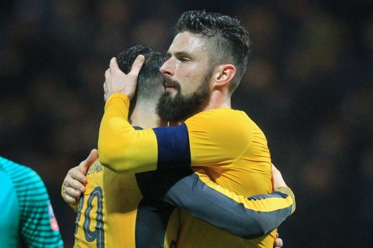 Arsenals French striker Olivier Giroud (R) embraces teammate Granit Xhaka after their English FA Cup match against Preston North on January 7, 2016