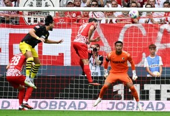 Mats Hummels scored goals in each half as Borussia Dortmund came back late to win 4-2 away at Freiburg on Saturday.