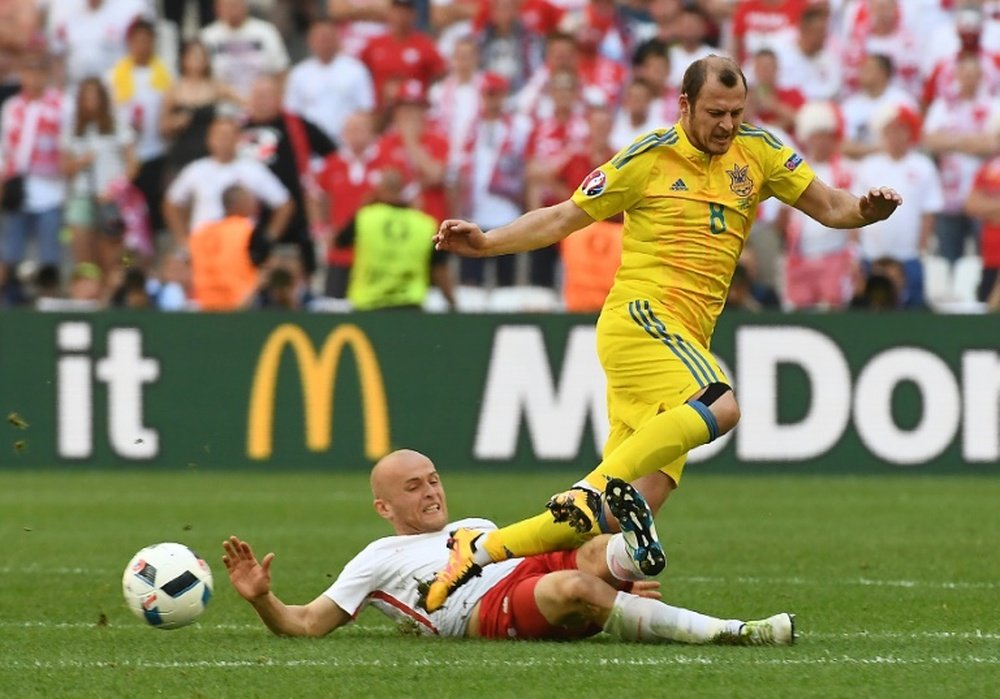 Polands defender Michal Pazdan (left) vies with Ukraines forward Roman Zozulya. AFP