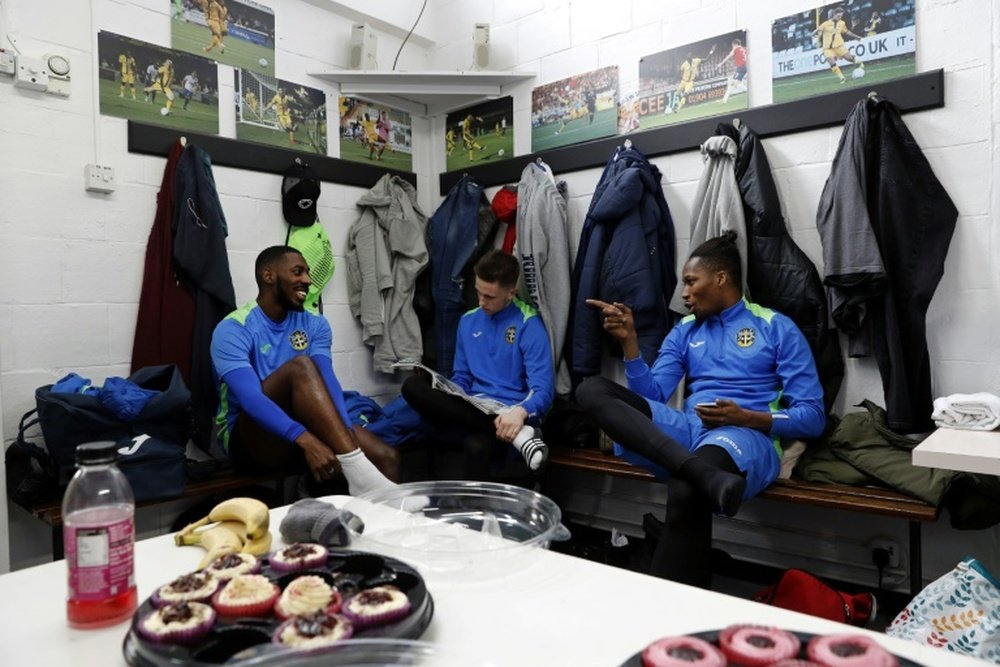 Sutton United players sit in the dressing room. AFP