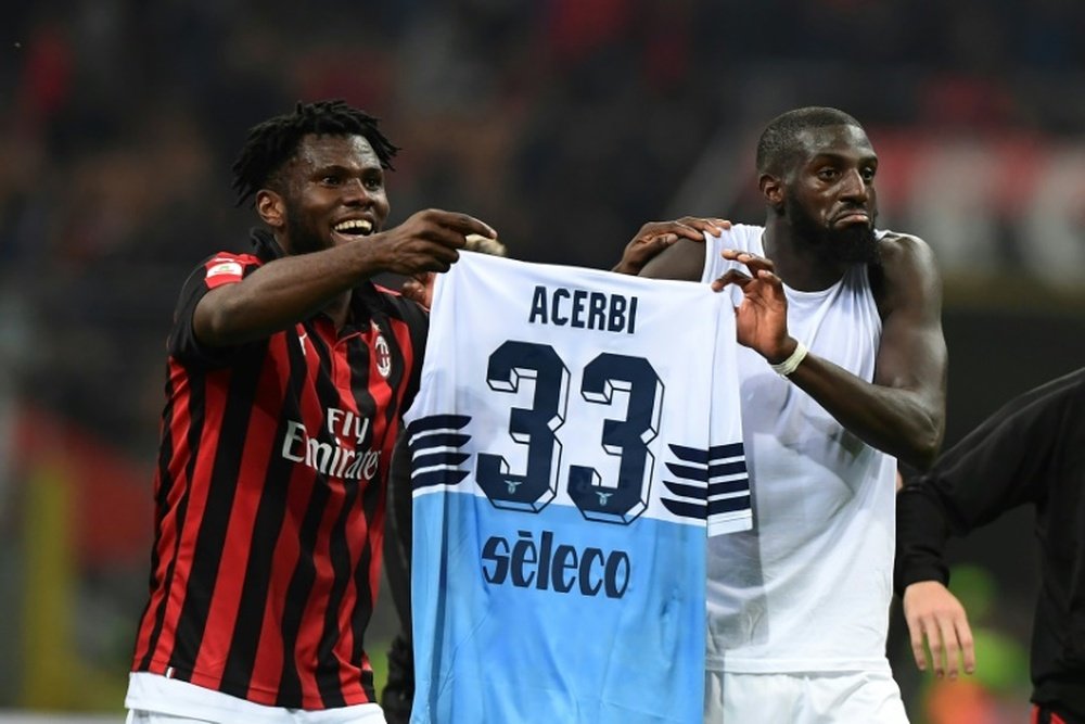 Franck Kessie and Tiemoue Bakayoko lifted the jersey of Francesco Acerbi after beating Lazio. AFP