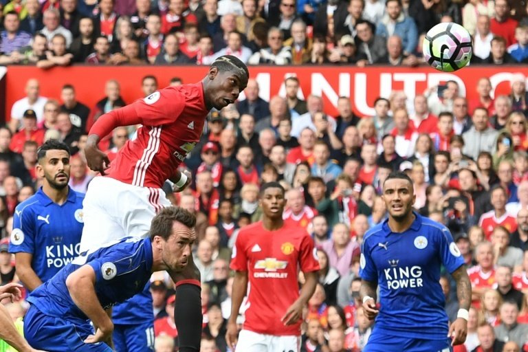 Paul Pogba heads his side's fourth goal against Leicester City at Old Trafford. AFP
