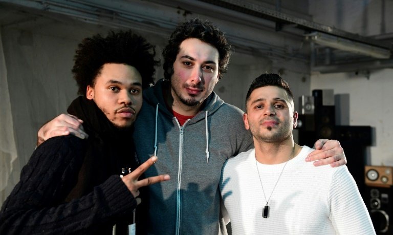 (From L) Actors Nyamandi Mushayavanhu, Daniel Mandolini and Tamer Arslan pose after the premiere of the theatre play Peng Peng Boateng, in Berlin, on December 18, 2016