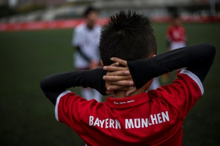 A Chinese boy takes part in a training session after the opening ceremony of Bayern Munichs office i