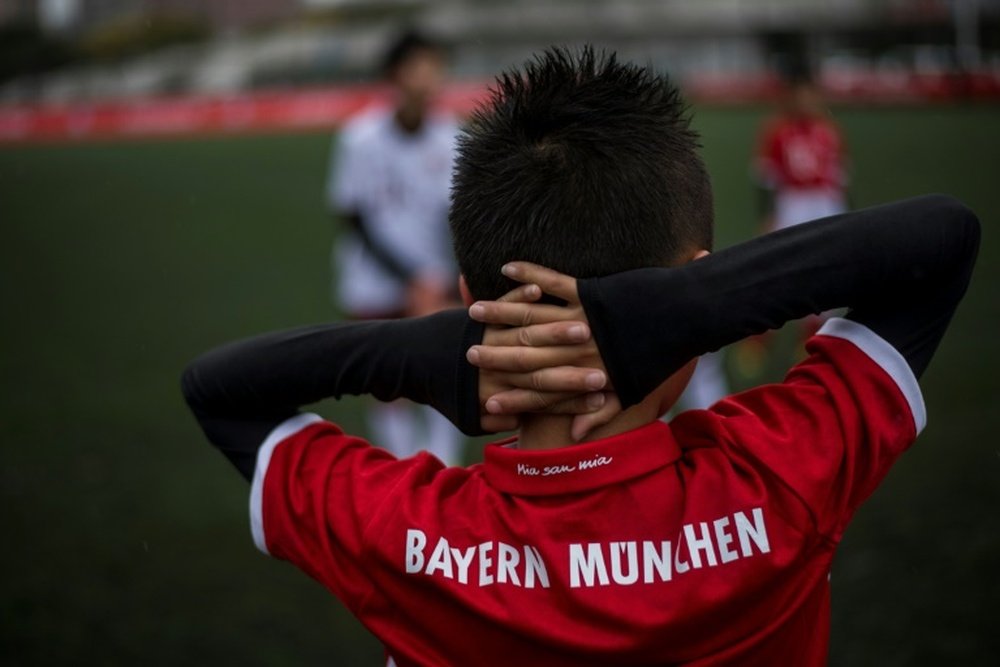 A Chinese boy takes part in a training session after the opening ceremony of Bayern Munichs office i