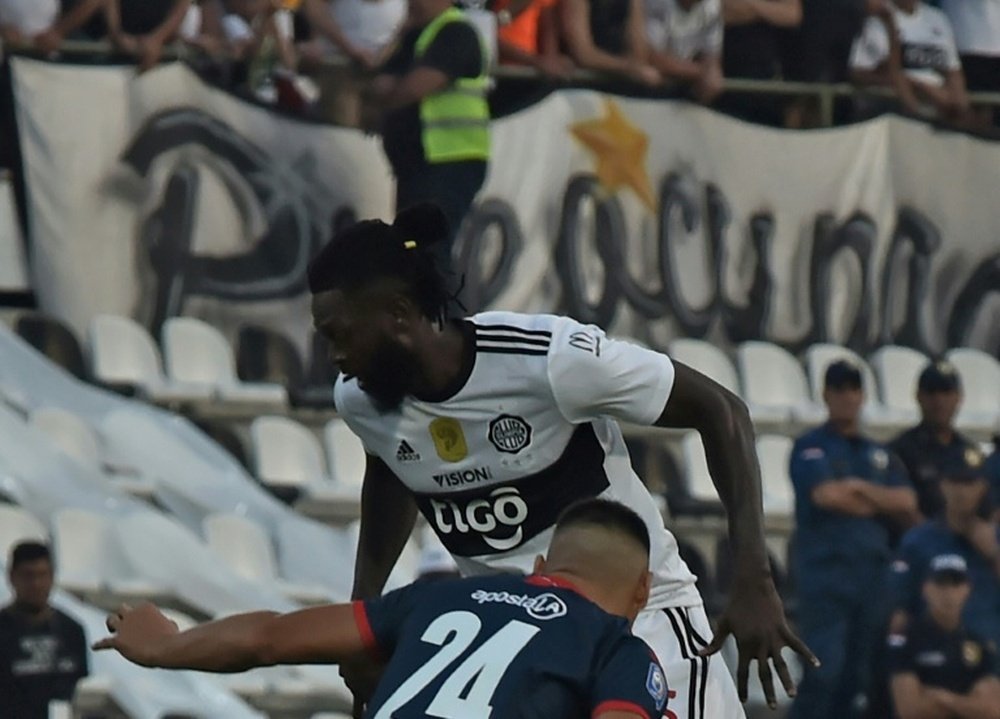 Adebayor (top) made his Olimpia debut on Sunday. AFP