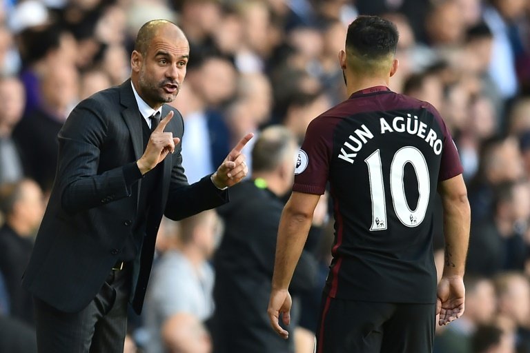 Manchester Citys manager Pep Guardiola (L) gestures to Manchester Citys Argentinian striker Sergio Aguero during the English Premier League football match between Tottenham Hotspur and Manchester City