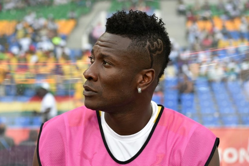 Ghanas forward Asamoah Gyan who is recovering from an injury sits on the bench durin. AFP