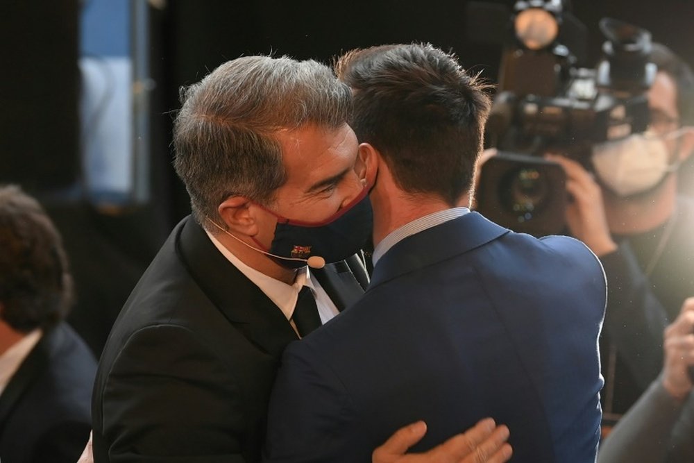 Laporta (L) believes Messi (R) will be a Barca player next season. AFP