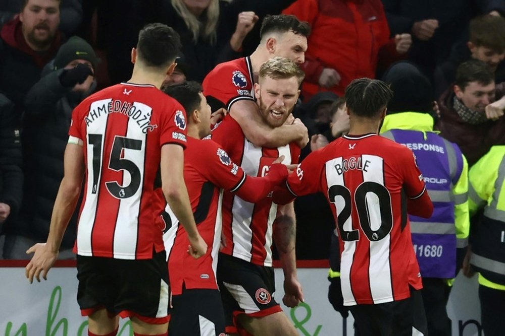 McBurnie (C) scored a 102st-minute penalty to salvage a 2-2 draw for Sheffield United. AFP