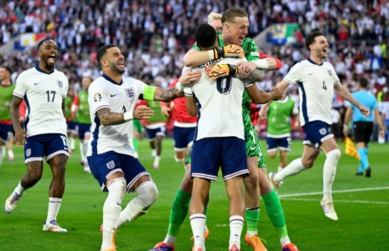 Pickford (green shirt) saved a penalty while Trent Alexander-Arnold (8) netted the winner. AFP