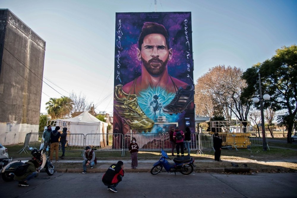 A mural of Lionel Messi looms over the playground of his former school. AFP