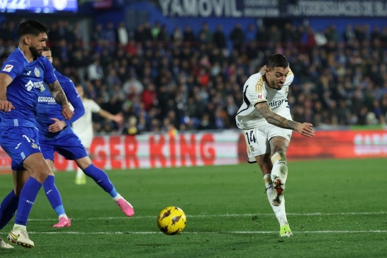 Joselu fired home his second goal to help Los Blancos move top of the league at Getafe. AFP