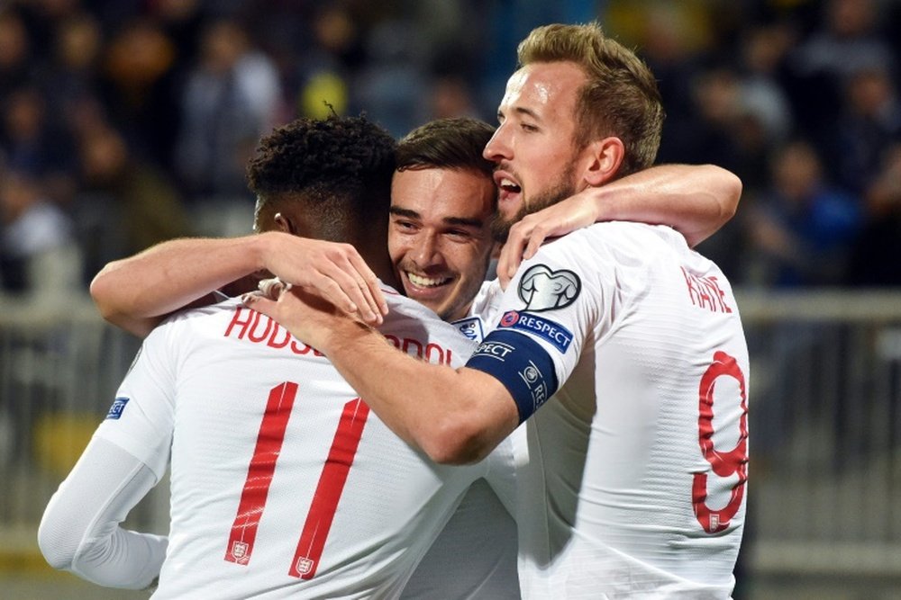 England's Harry Winks (C) celebrates after scoring the opening goal against Kosovo. AFP