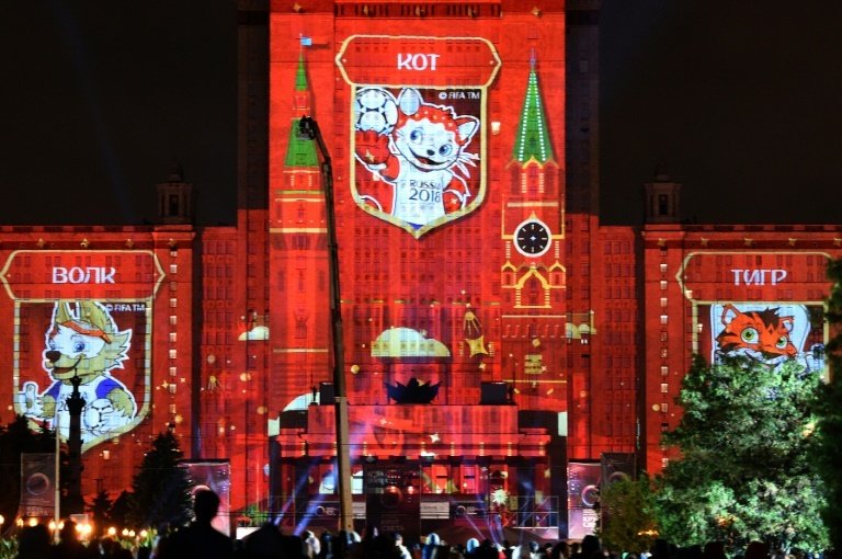 Pictures of candidates for the official mascot of the 2018 FIFA World Cup in Russia, including (L-R) a wolf, a cat and a tiger, are projected onto Moscow State University