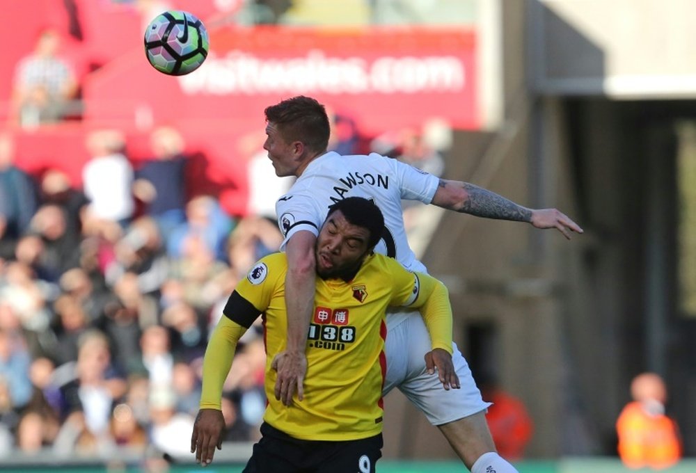 Swansea City's Alfie Mawson vies with Watford striker Troy Deeney. AFP