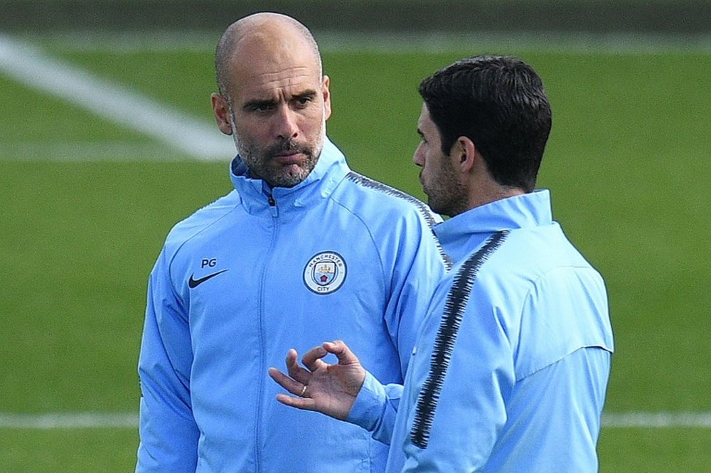 Manchester City manager Pep Guardiola (left) and assistant coach Mikel Arteta. AFP