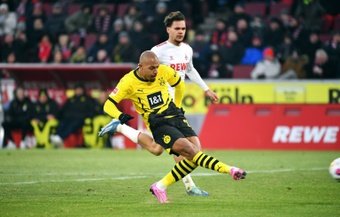 Donyell Malen scored a brace as Borussia Dortmund beat Cologne 4-0 on Saturday in a match delayed for eight minutes after protesting fans threw chocolate coins in gold foil onto the pitch.
