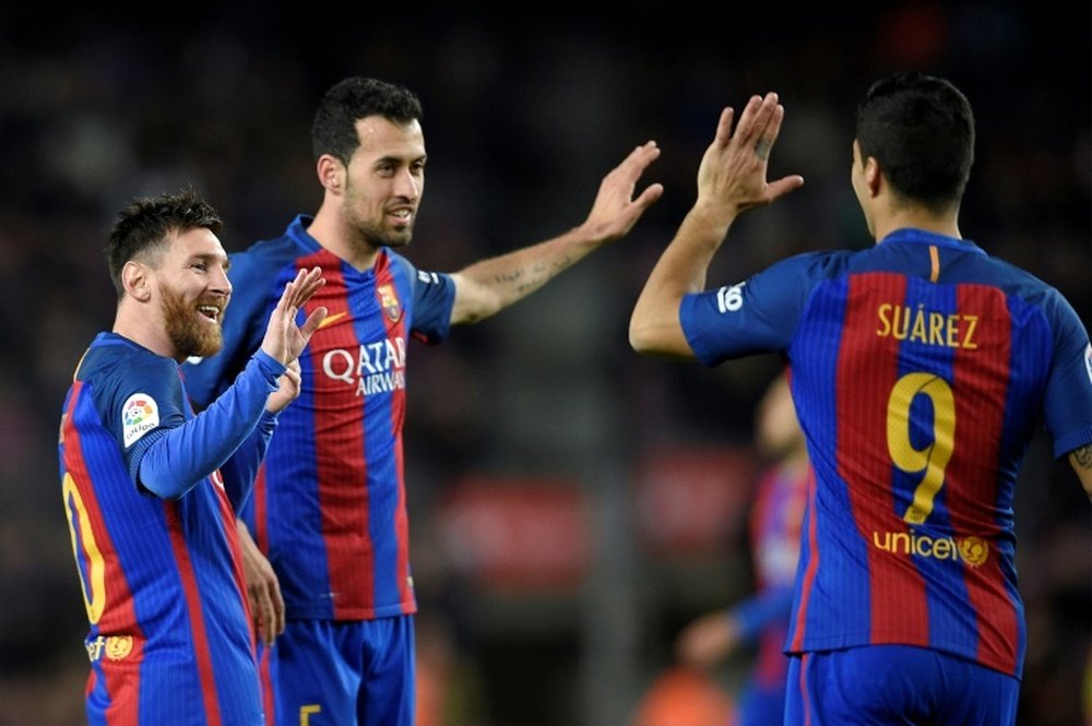 Messi, Suarez and Neymar send Barelona top in Sporting rout. AFP
