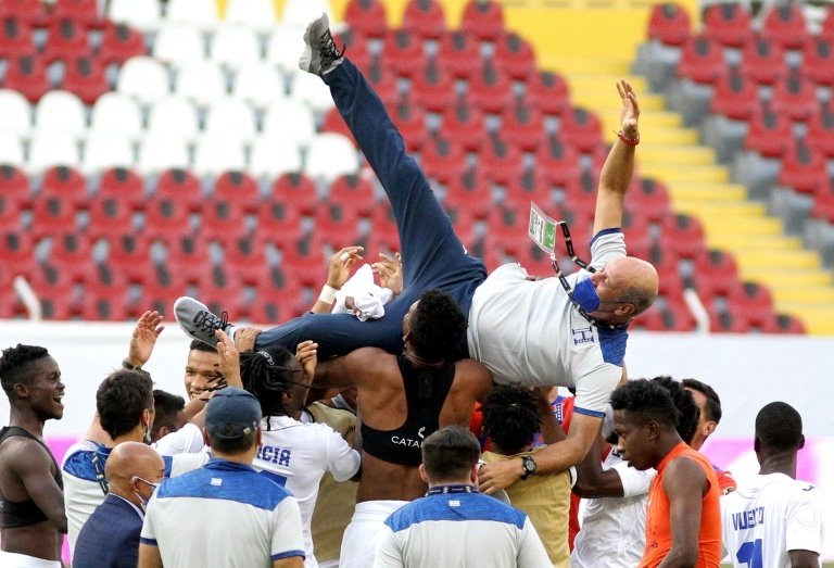 Honduras players lift coach Miguel Falero as they celebrate their passage to the Tokyo Olympics. AFP