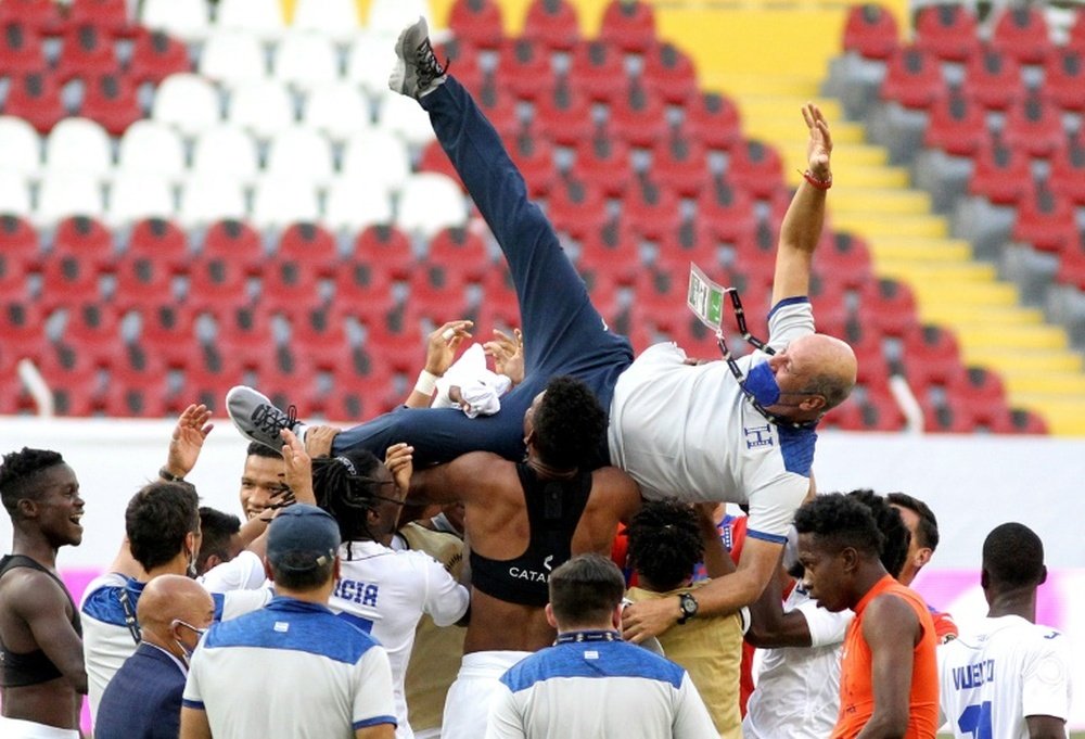 Honduras players lift coach Miguel Falero as they celebrate their passage to the Tokyo Olympics. AFP