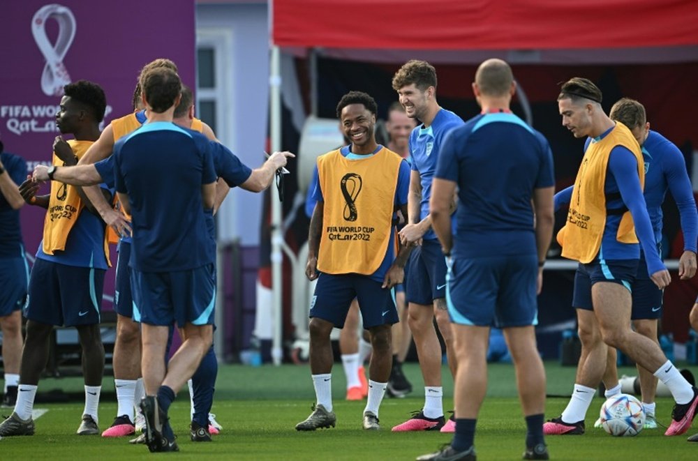 Raheem Sterling (C) is back in Qatar after returning home last week. AFP