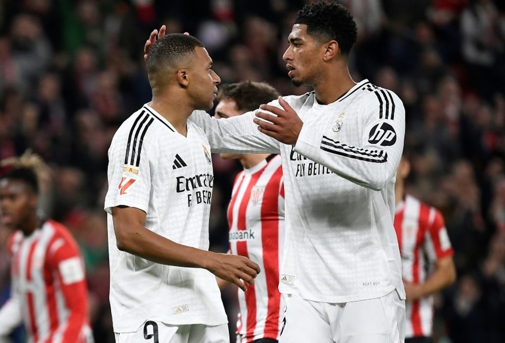 Kylian Mbappe (L) was comforted by Jude Bellingham after missing his penalty. AFP