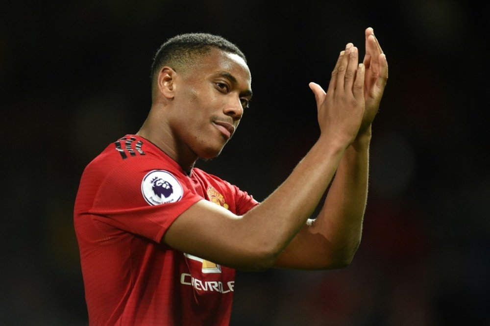 Martial says he is 'loving his time at the club' as he signs new deal. AFP
