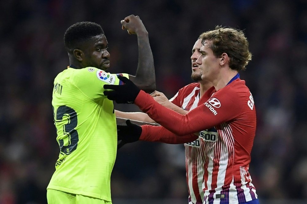 Umtiti and Griezmann pictured during a tussle. AFP