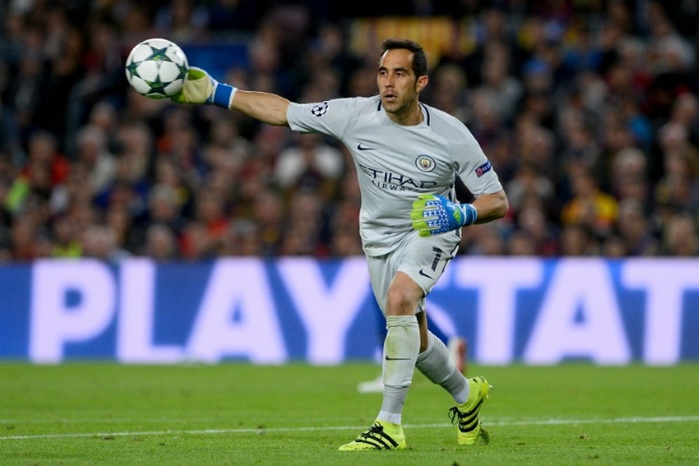 Manchester Citys Chilean goalkeeper Claudio Bravo throws the ball during the UEFA Champions League football match FC Barcelona vs Manchester City at the Camp Nou stadium in Barcelona on October 19, 2016