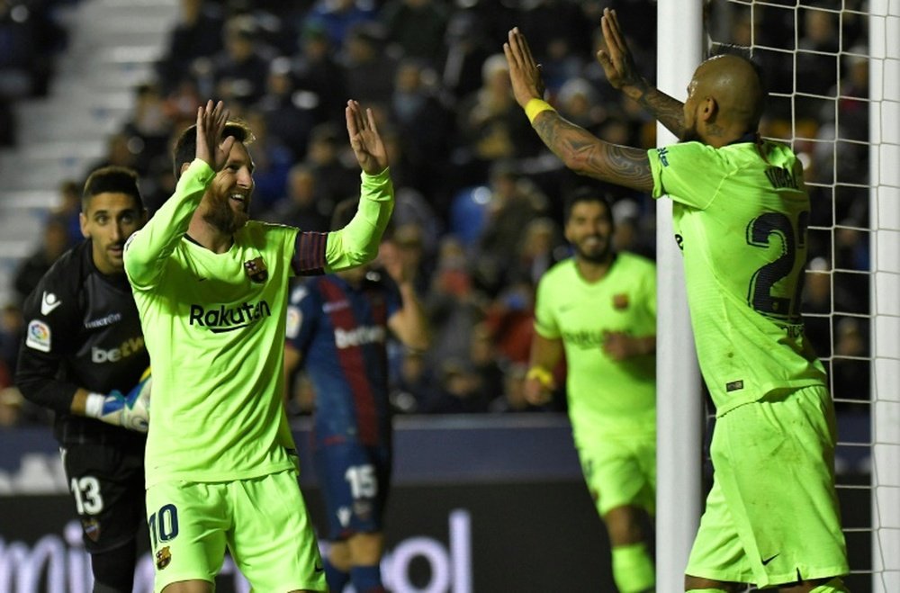 Lionel Messi, auteur dun triplé, félicite Arturo Vidal passeur sur le 4e but du Barça à Levante. AFP
