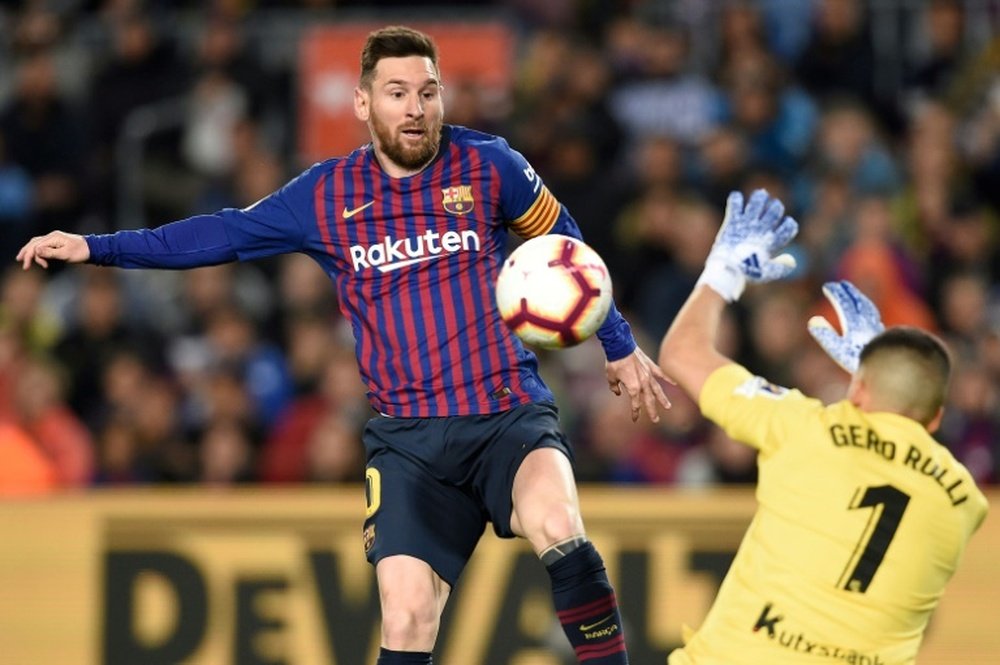 Lionel Messi à la lutte avec le gardien dde la Real Sociedad Geronimo Rulli. AFP