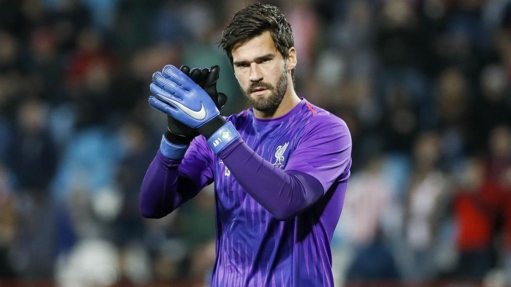 Alisson is vying for position. GOAL