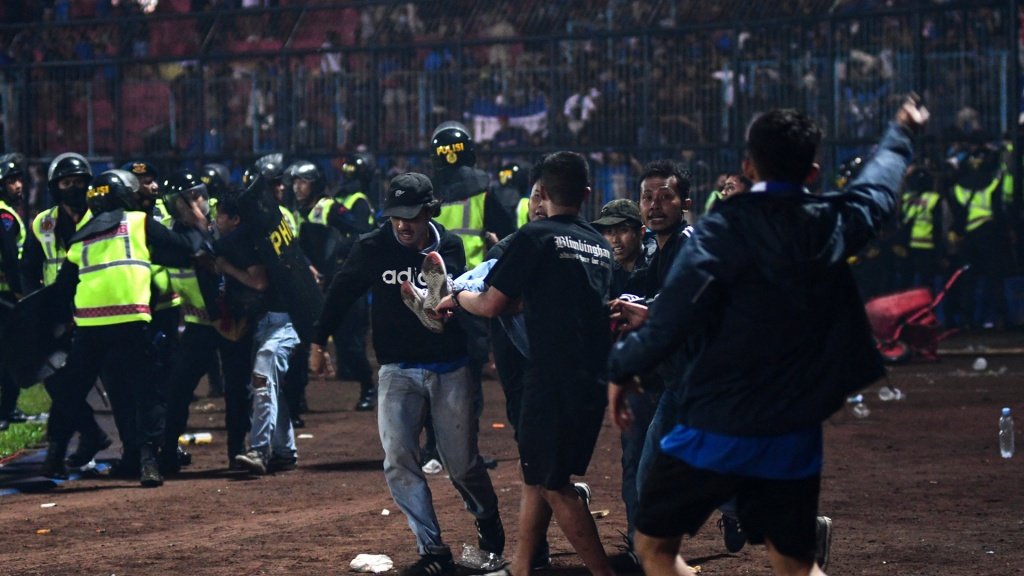 At least 129 fans killed after riot. GOAL