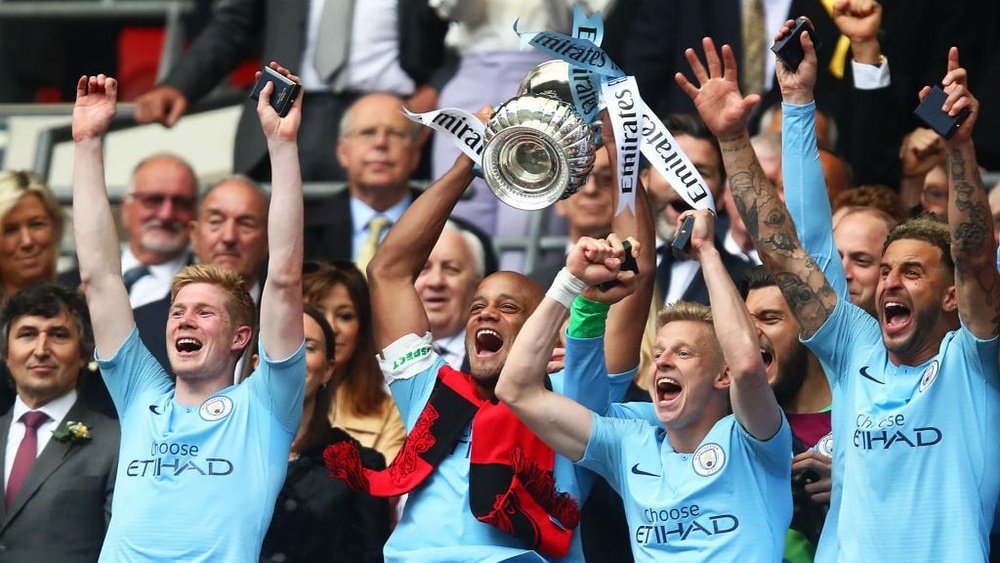 Vincent Kompany with the FA Cup trophy. GOAL