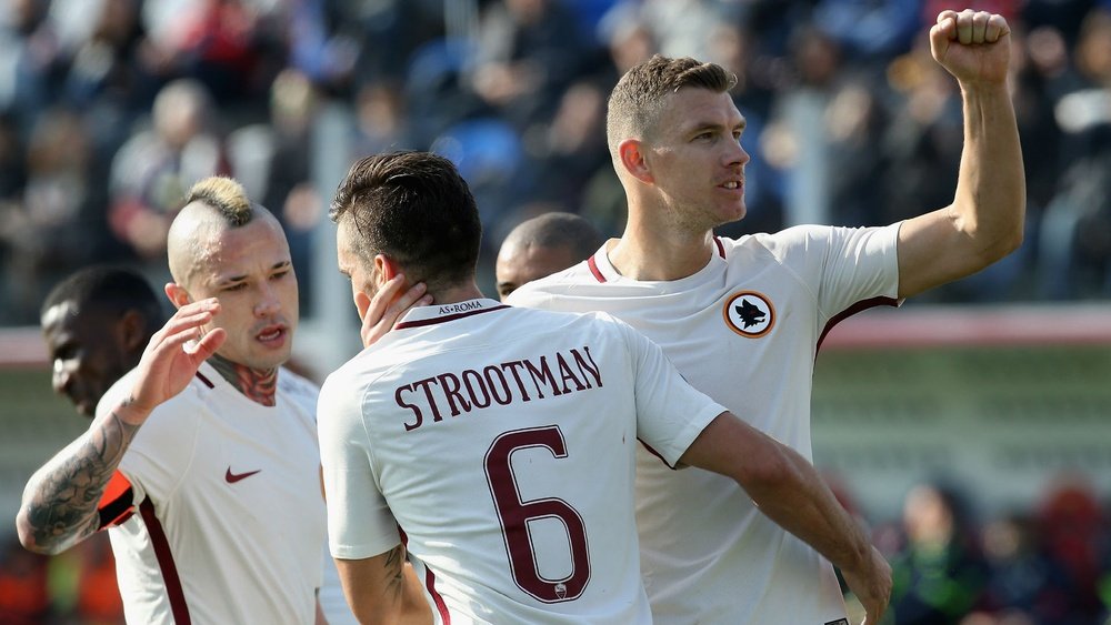 Edin Dzeko (right) celebrating with his Roma team-mates. Goal