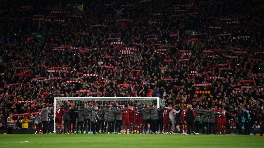 Liverpool's players celebrated with their fans at the Kop end after the game. GOAL