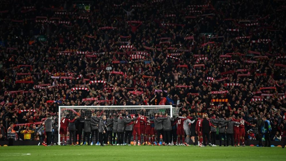 Liverpool's players celebrated with their fans at the Kop end after the game. GOAL